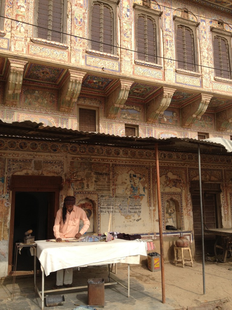 Common to see awning, signs and paintings over the top of the haveli artwork and businesses like this laundry.